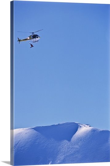 Snowboarder being dropped from a helicopter 