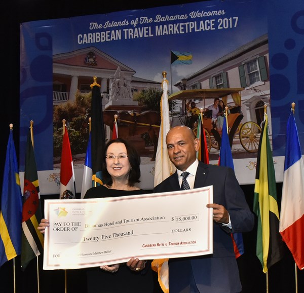 Caption - L-R - CHTA President, Karolin Troubetzkoy presents $25,000 check to Carlton Russell, BHTA President